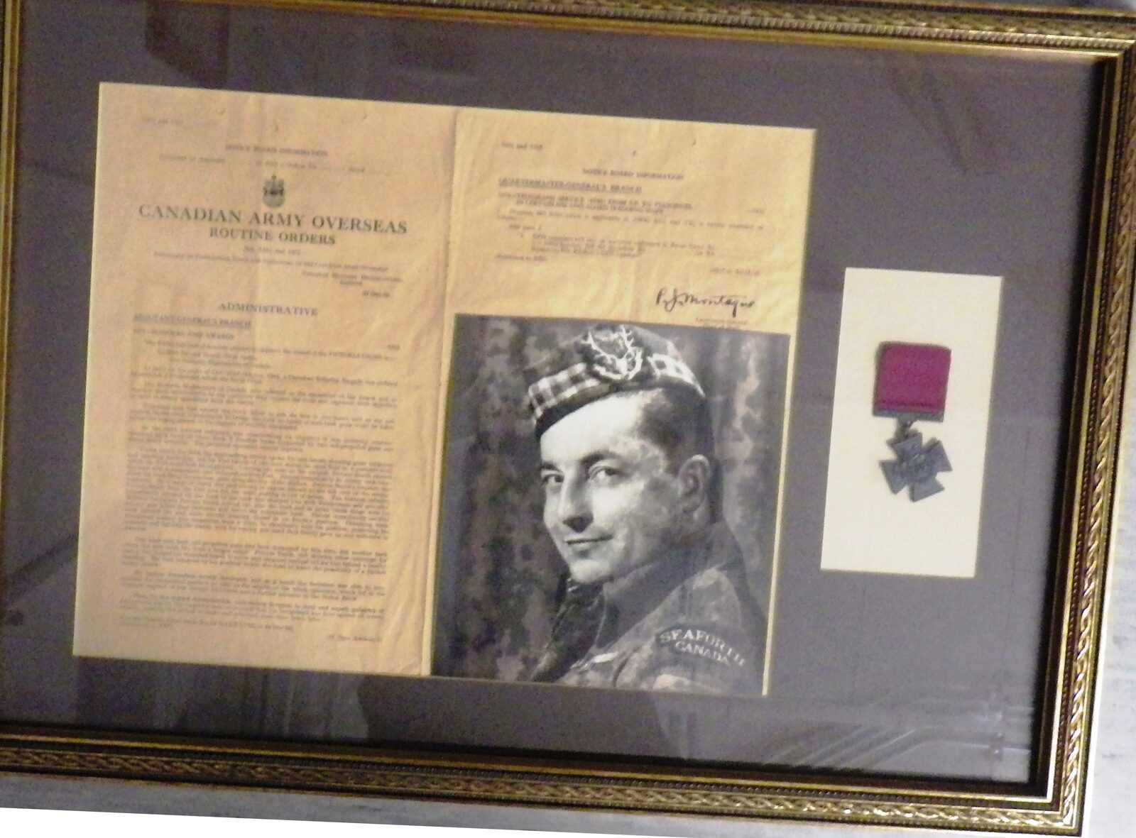 Pte Smokey Smith VC shadowbox — Canadian Army Overseas citation, his Seaforth Highlanders portrait, and the Victoria Cross
