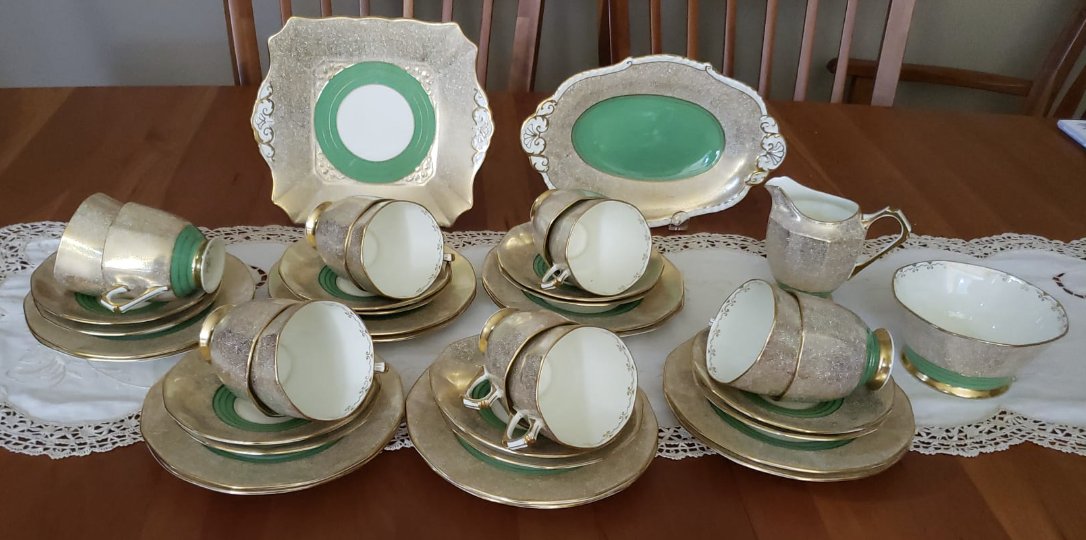 The full Tuscan gilt-and-green tea service — cups, saucers, trios, cake plate, sandwich tray, milk jug and sugar bowl
